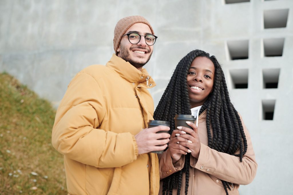 a man and a woman is holding a cup of coffee