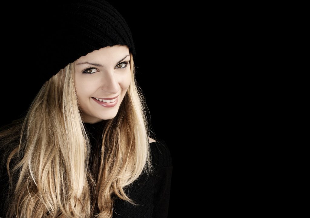 happy woman wearing black clothes and black bonnet
