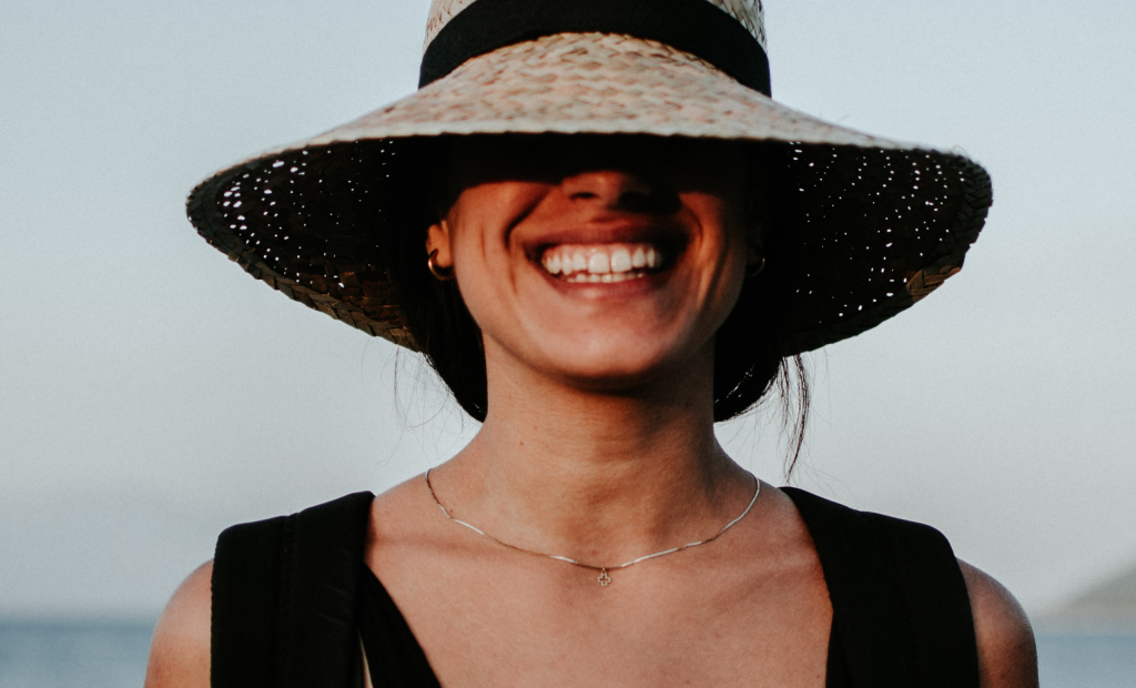 a cheerful woman wearing a hat