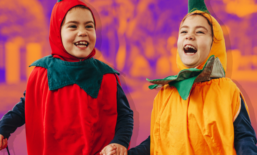 two happy kids are wearing a fruit costume