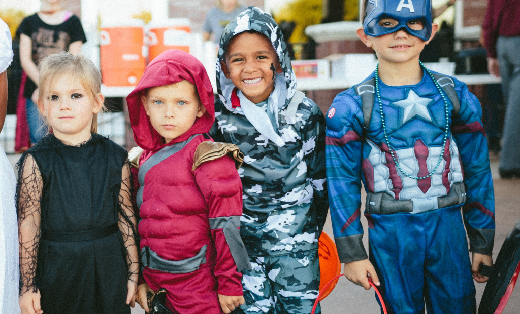 happy kids wearing super hero costumes