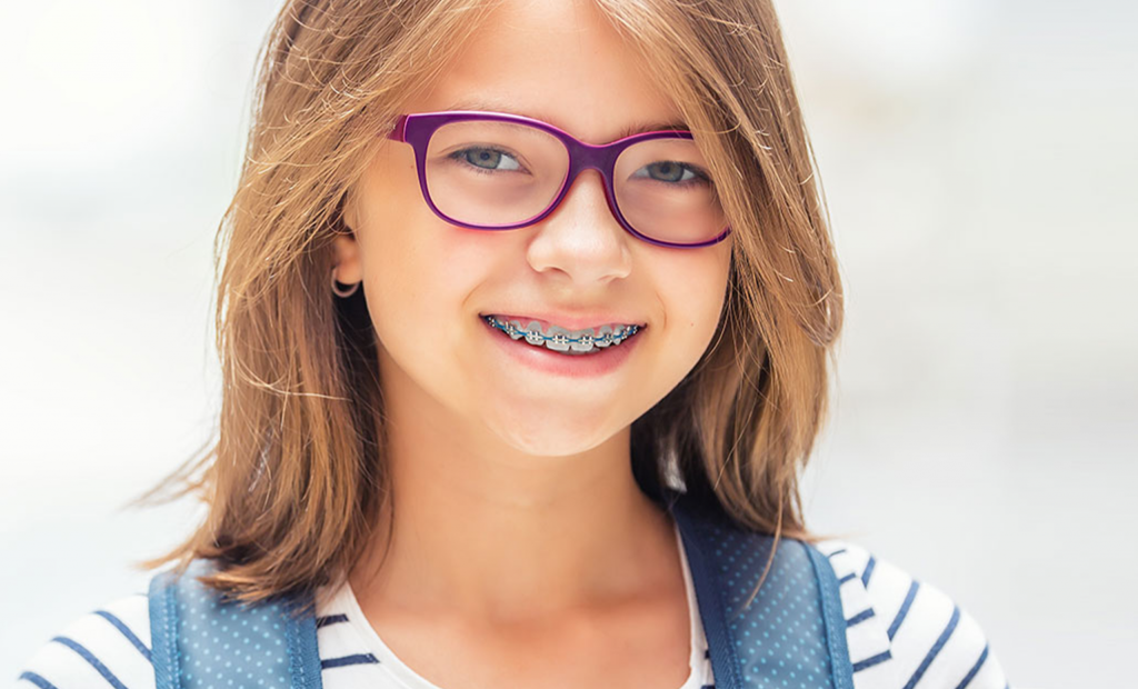 a pretty girl with violet eyeglasses is wearing a braces