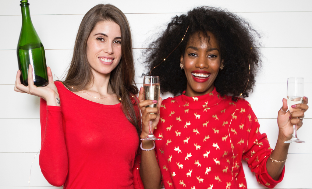 women holding glasses of wine is celebrating new year