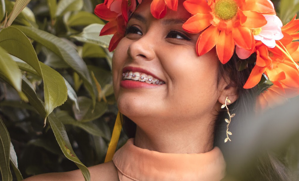 a woman with braces wearing a flower crown