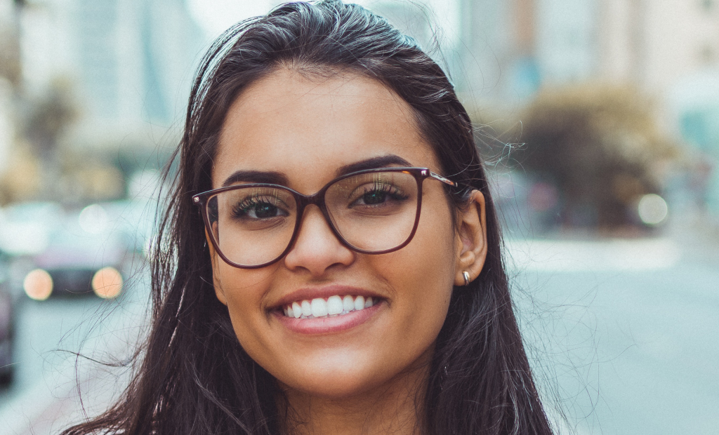joyful woman wearing an eyeglasses is smiling