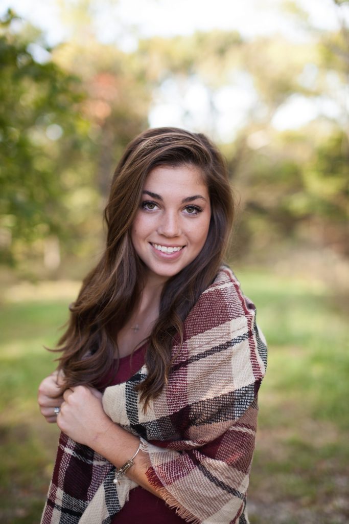 cheerful woman with brown hair wearing a scarf