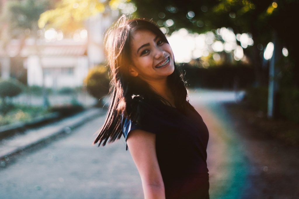 woman with braces wearing black top