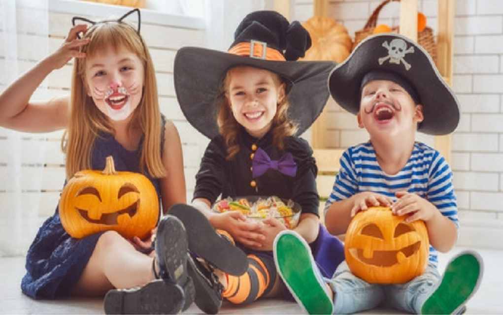 three kids wearing a halloween costumes