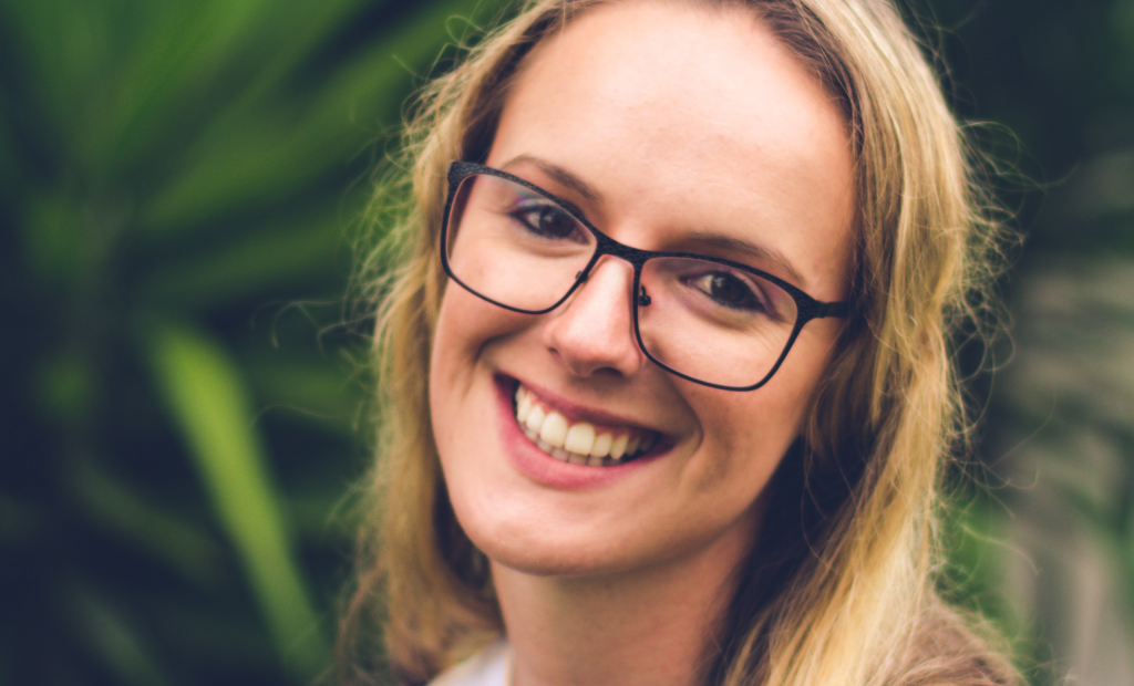 a smiling woman with eyeglasses