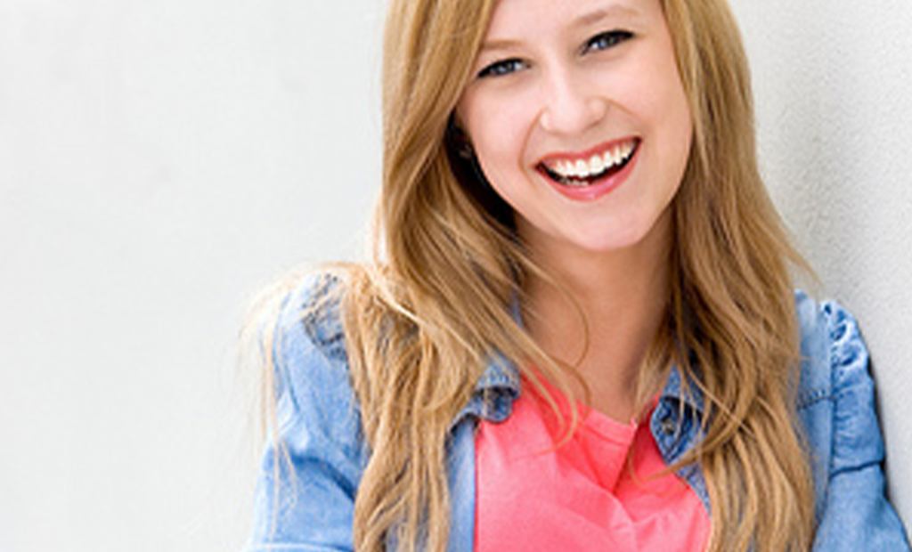 happy woman wearing a denim jacket
