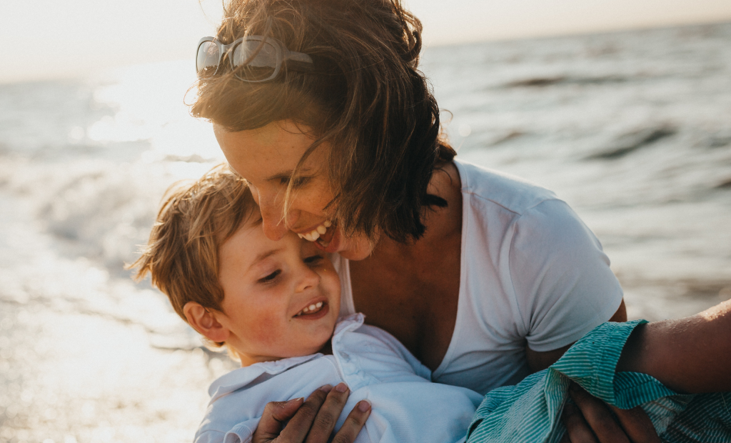mother and son playing on the beach