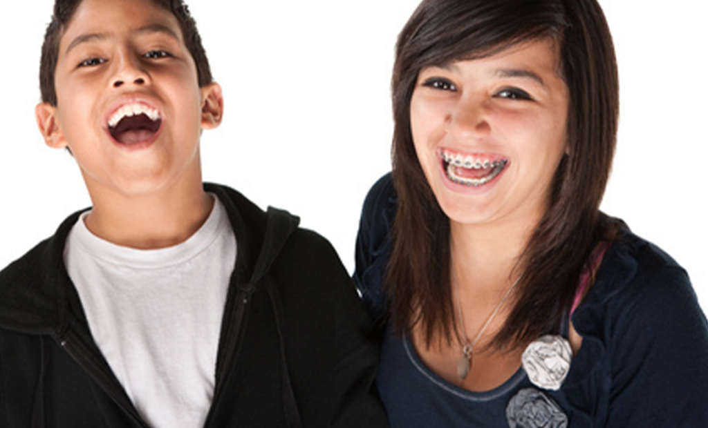 a happy girl with braces and a boy wearing black jacket