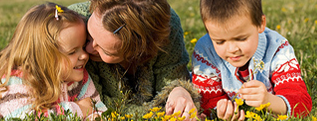 mother and kids playing on the ground