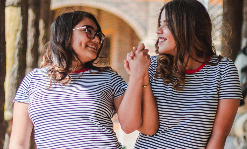 two girls wearing same shirt with stripes