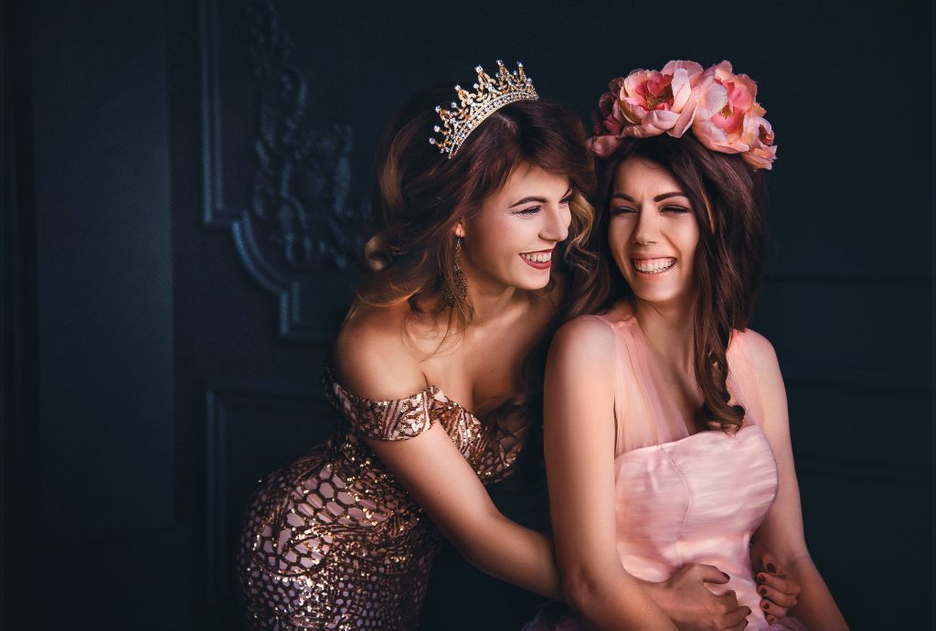 two girls wearing a crown