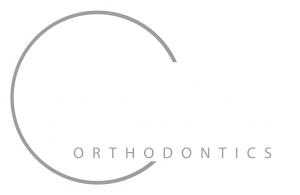 Dr. Whitlock Orthodontics white logo