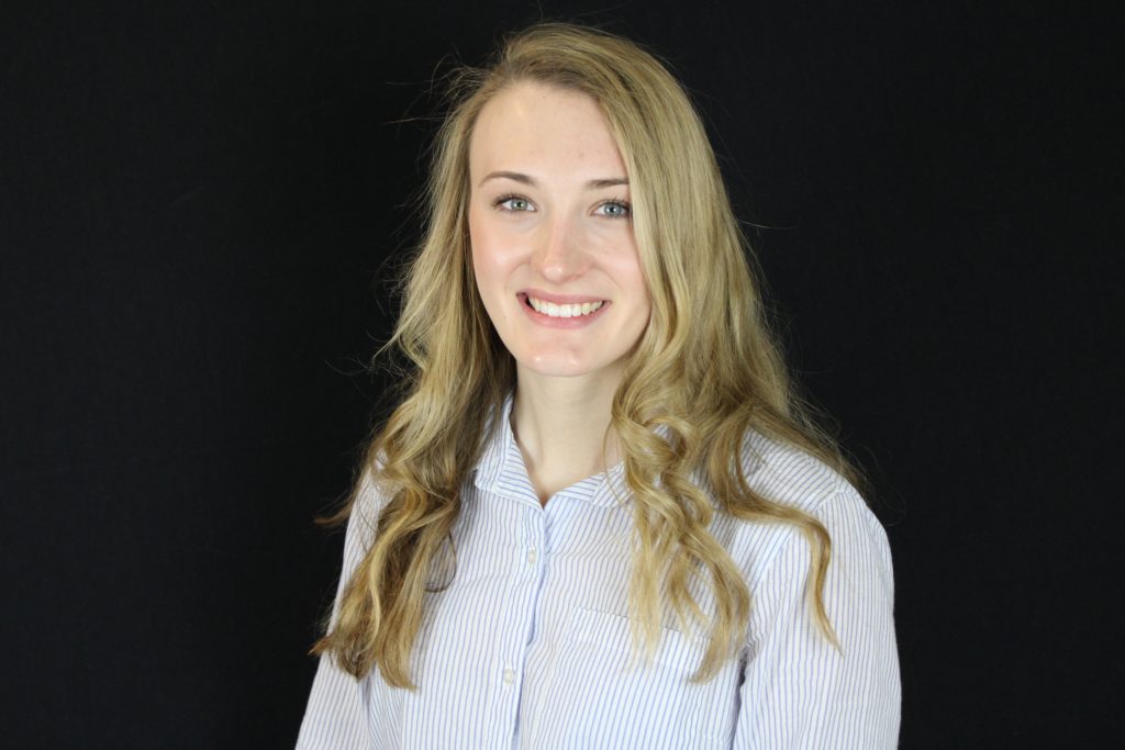 a cheerful women with blonde hair showing her white teeth